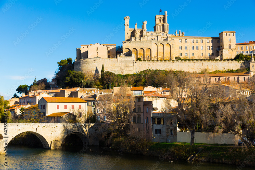 View of Cathedral of Saint Nazaire and Old Bridge across Orb river, Beziers, France