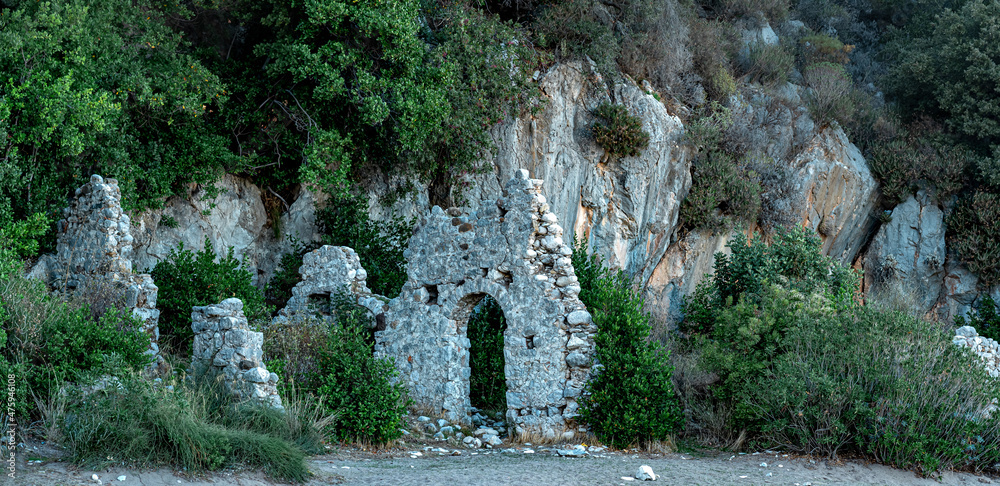 Naklejka premium ruins of ancient building on the background of mountains in the antique city of Olympos, Turkey