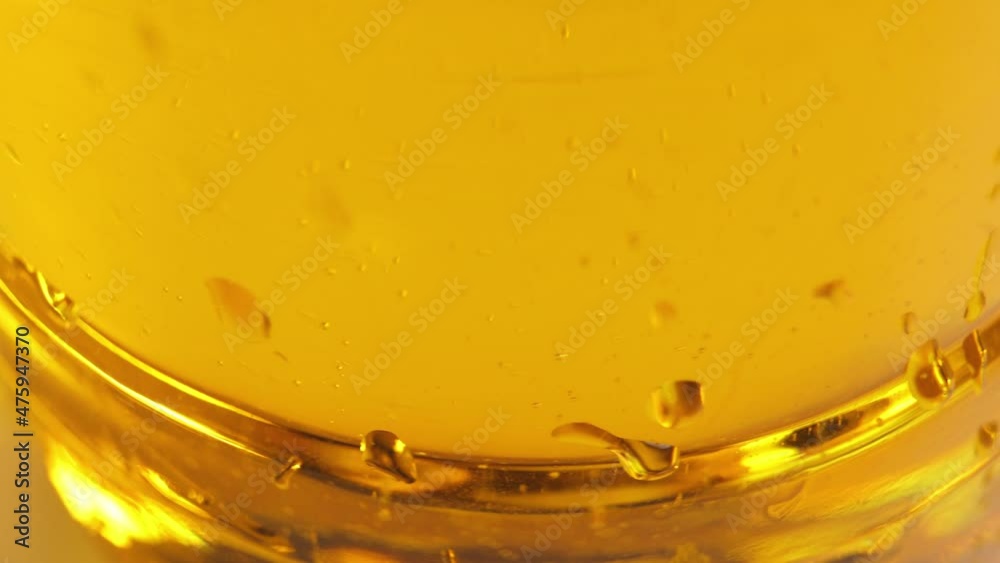 Vegetable oil in motion. Yellow liquid close up. Vegetable oil in motion. Yellow liquid close up.