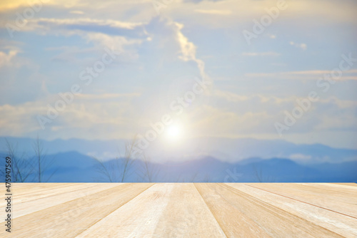 Empty top wooden table on soft focus blurred sky sunset on the mountain for background