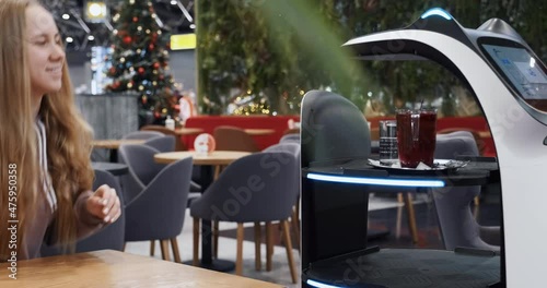 Automatic robot waiter brings order to young woman in the restaurant. Programmed robotic machine with screen brings tray to client. No logo and free from intellectual property device
