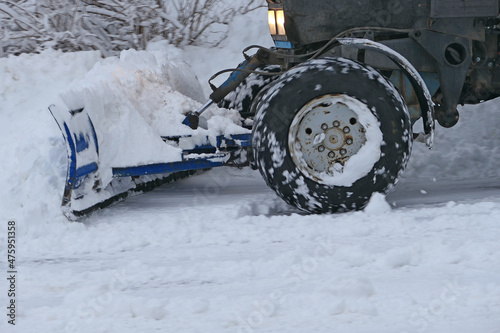 Snowfall. Machines for cleaning snow. The tractor removes snow on the roads of the city. Winter cyclone. High quality photo