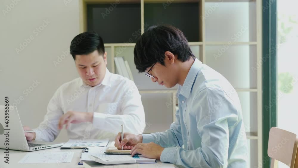 Businessman explaining numeric graphs on computer to colleagues. Businessman explaining numeric graphs on computer to colleagues.