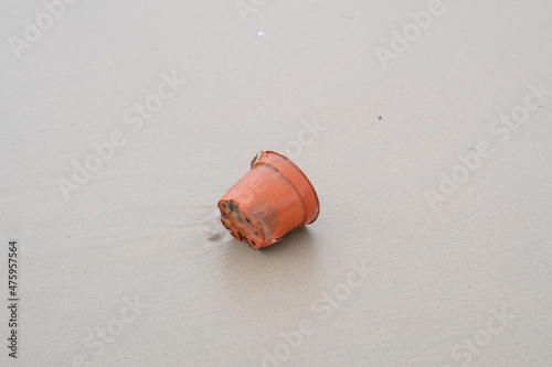 Plastic container on the seashore of Port Dickson beach, Negeri Sembilan state, Malaysia. Environmental damage of garbage plastic problems on the shore. 