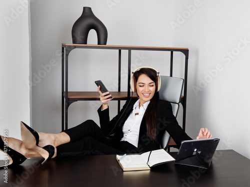 Happy  Businesswoman or Student with headphones in office 