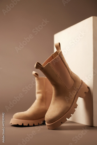 Obraz na płótnie Trendy boots with wooden wall. fashion female shoes still life w salonie