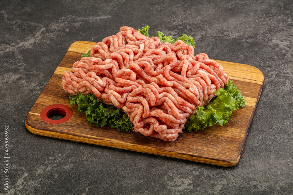 Raw pork minced meat over board Raw pork minced meat over board
