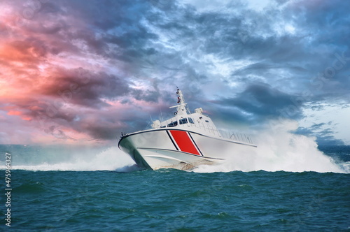 Fototapeta coast guard boat serving in severe storm