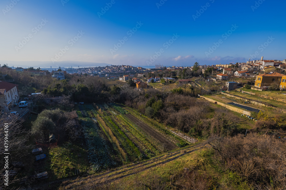 Views from former train track between Trieste and Kozina, above valley of Glinscica or Rosandra on a sunny winter day. View of city of trieste below