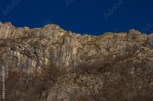 Views from former train track between Trieste and Kozina, above valley of Glinscica or Rosandra on a sunny winter day.  View of cliffs above path. photo