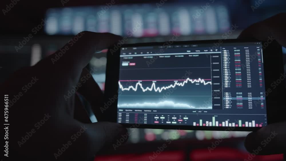 Young person daily trading on crypto stock app interface on mobile smartphone Young person daily trading on crypto stock app interface on mobile smartphone