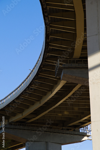 A bridge element with a bend in the roadway. The design of the automobile bridge. The span of the bridge with a turn from below.