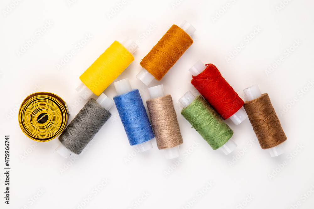 Sewing threads, sewing centimeter or measuring tape, isolated on white background.