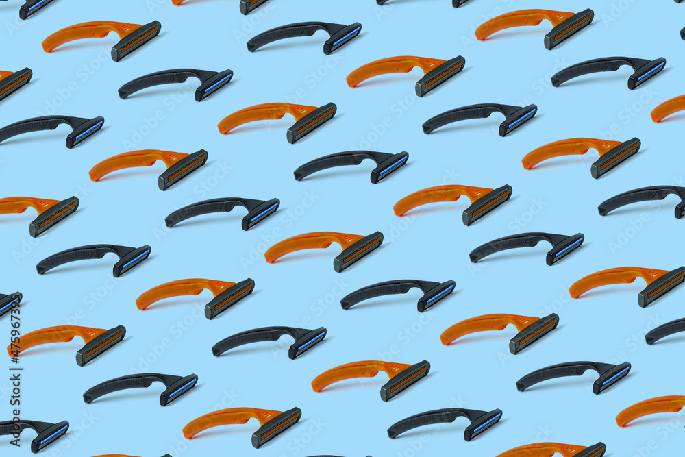 Fototapeta premium Orange and black three-blade safety razors. Seamless repeating pattern.