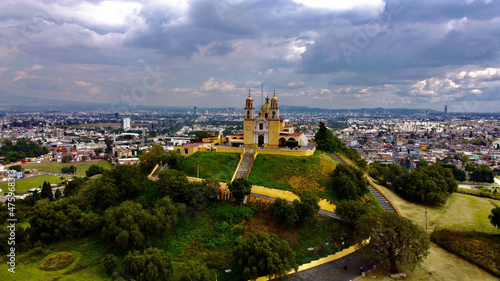 Beautiful view of Cholula Mexico church on a pyramid in Puebla under the cloudy sky photo