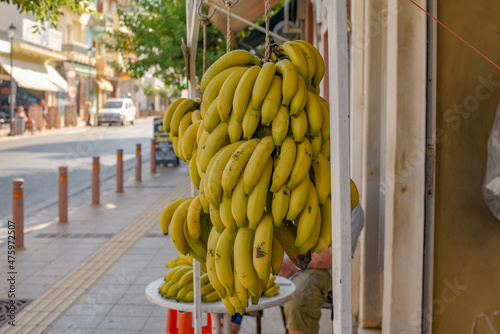 Closeup shot of a bunch of ripe bananas hanging outdoors in the market of Malia, Crete, Greece