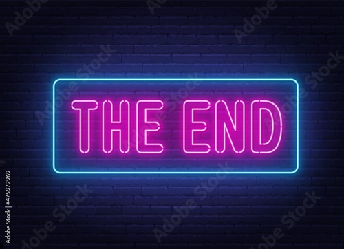The end neon sign on brick wall background. photo