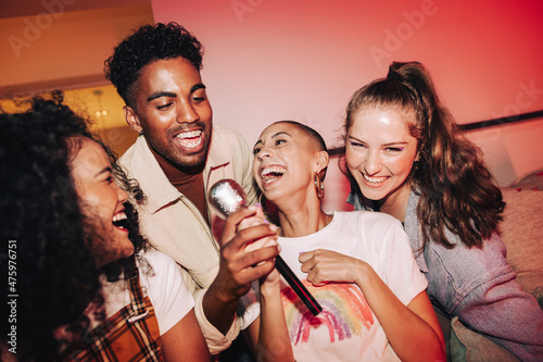 Vibrant friends enjoying karaoke night together photo