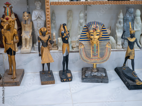 Stone statuettes of Egyptian gods on display in a souvenir shop. Selective focus. Luxor, Egypt.