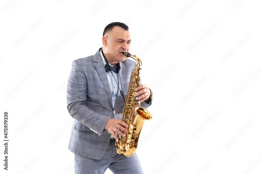Fototapeta premium Emotional Musician man in a suit plays on saxophone isolated on white background