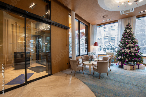 Canvas-taulu Interior of a hotel lobby with decorated Christmas tree