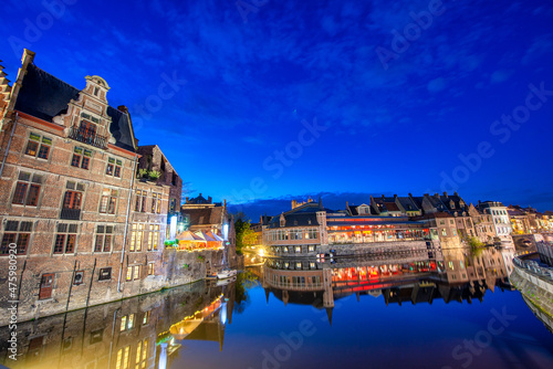 View of Graslei quay and Leie river in the historic city center in Gent, Belgium. Architecture and landmark of Ghent in spring season.