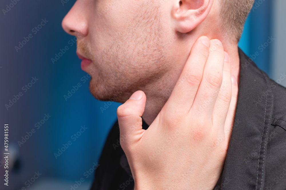 Young Caucasian male masseur doing self-neck massage to himself. Close-up. Myofasceal release Young Caucasian male masseur doing self-neck massage to himself. Close-up. Myofasceal release