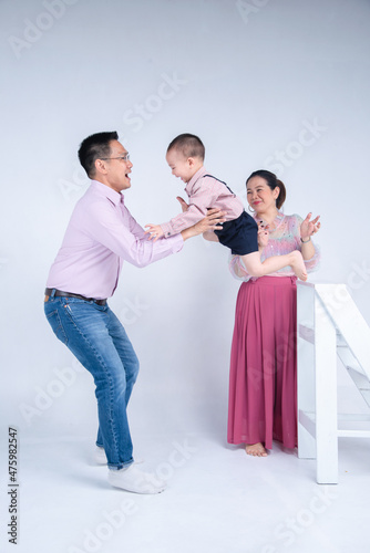 happy asian family , little todler son jumping to his dad