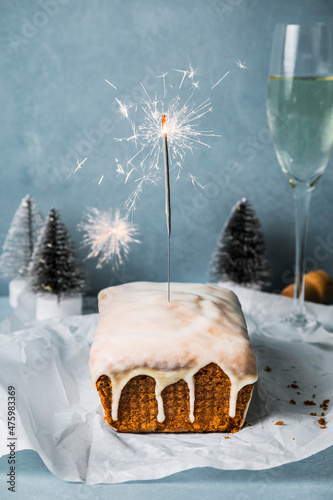 Orange bread cake with sparkler on table