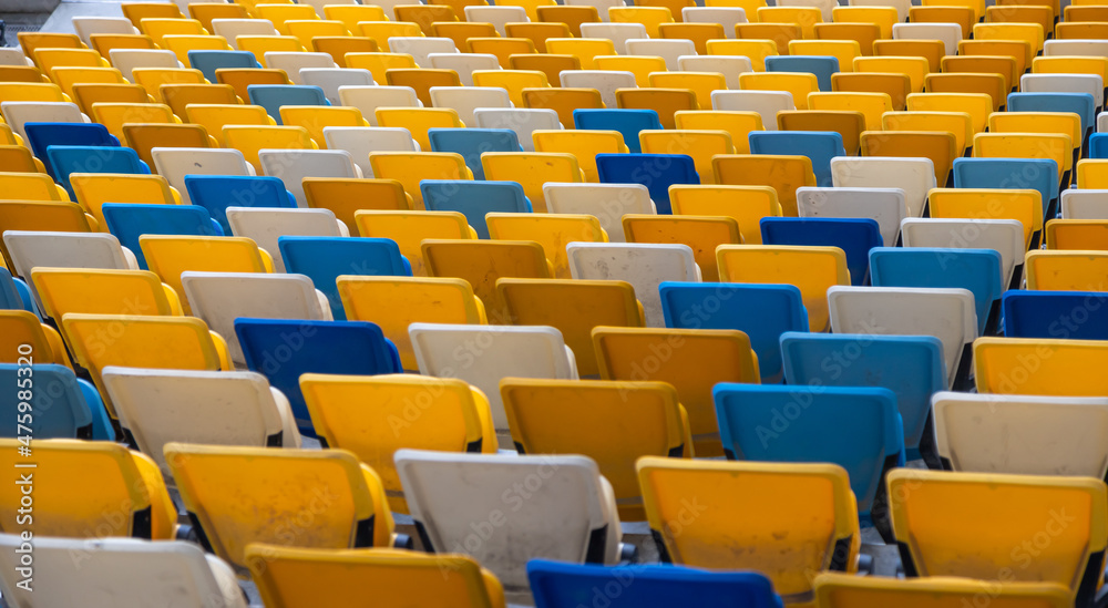 Fototapeta premium empty colorful seats on tribunes of stadium
