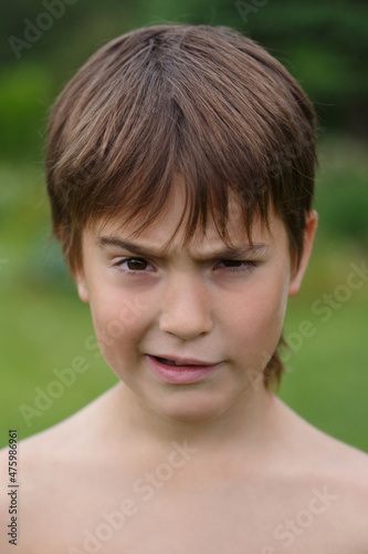 Portrait of a little boy grimacing outside © ksi
