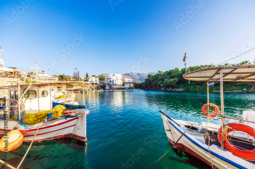 Greece, Crete, Sissi, Boats moored in marina of coastal village photo