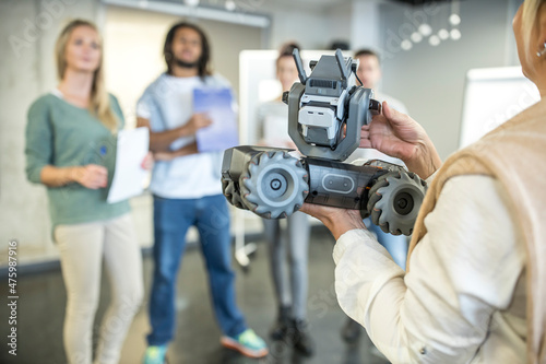 Developer introducing robotic combat tank model to team at workshop