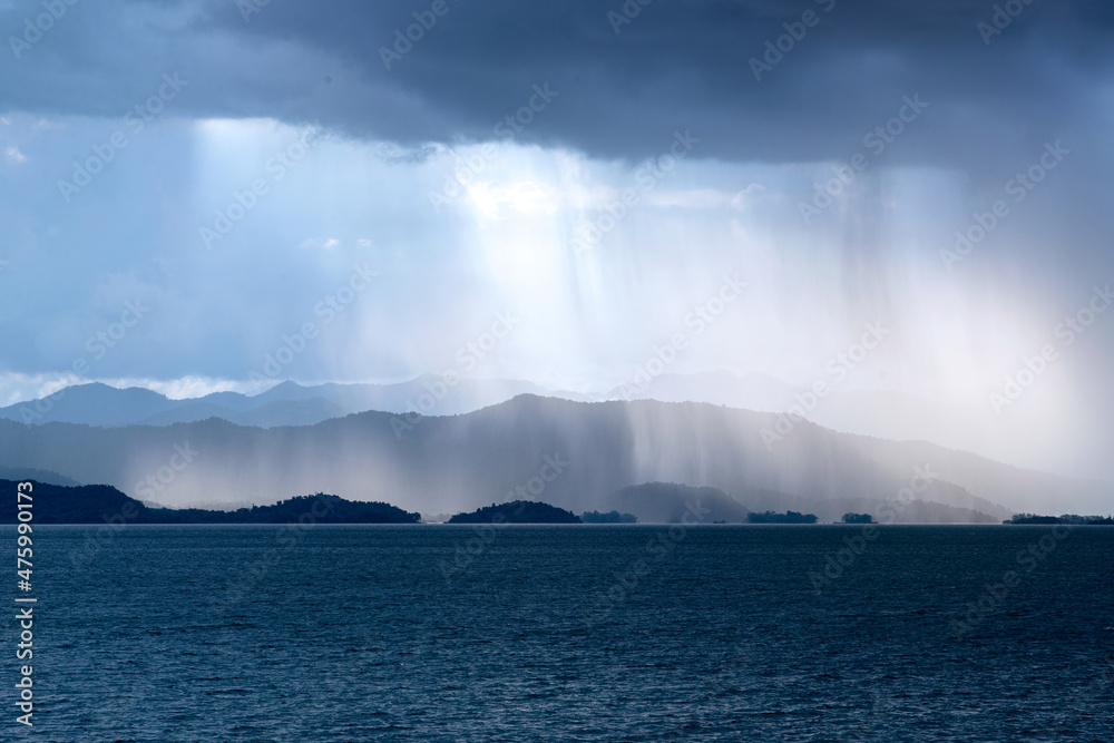 Landscape with lake under rain fall and dramatic cloudy sky, fall background