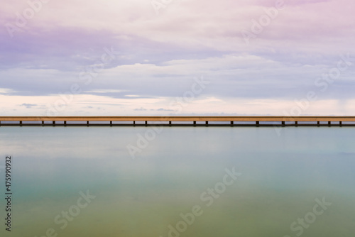 Puente sobre el mar y en la playa que cruza en la plazoleta El Cubo en Retamar, El Toyo photo
