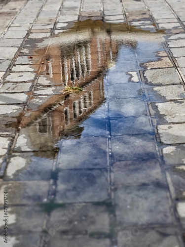 Old buildings shown in puddle as texture or background