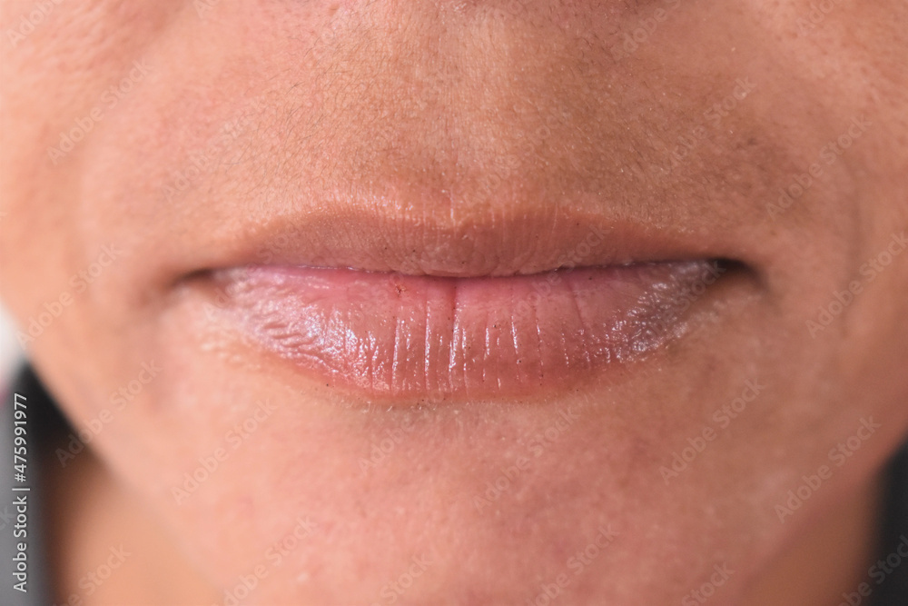 Indian woman lips closeup after applying lip balm on dry lips Indian woman lips closeup after applying lip balm on dry lips