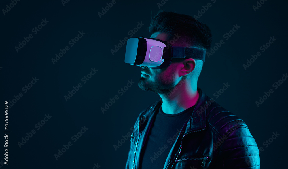 Man exploring virtual reality in VR goggles Man exploring virtual reality in VR goggles