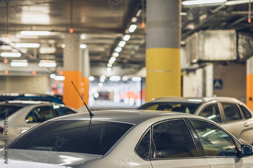 Parking garage, underground interior with parked cars. Defocused blurred background © svetlanais