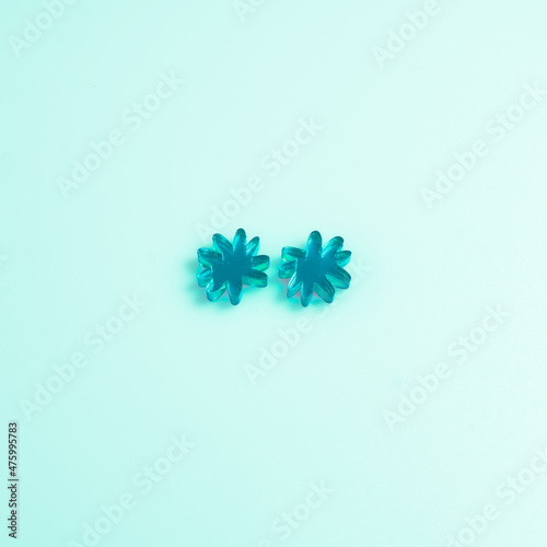 Material methacrylate with a flower shape design on a pastel color background. photo