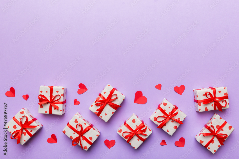 Valentine day composition: red gift box with bow and heart. Christmas present. View from above. Space for text. Holday greeting card