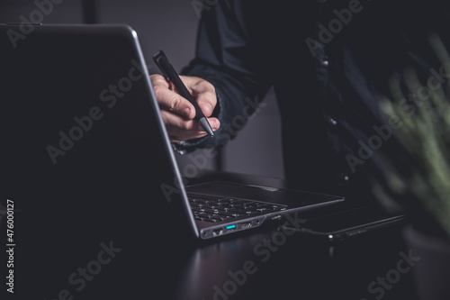 Businessman using a smartphone and notebook in a moddy office photo