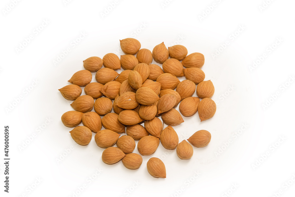 Heap of shelled apricot kernels on a white background Heap of shelled apricot kernels on a white background