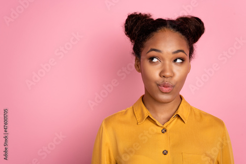 Photo of youth african lady curious look empty space thoughtful pouted lips isolated over pink color background