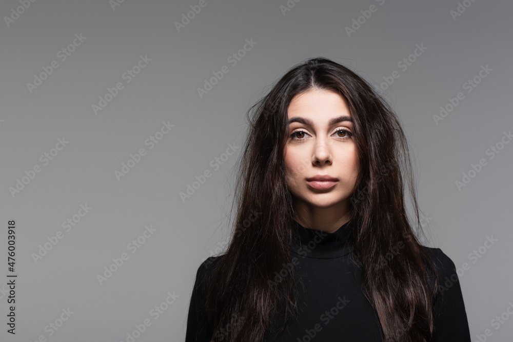 young woman in black turtleneck with tousled hair isolated on grey young woman in black turtleneck with tousled hair isolated on grey