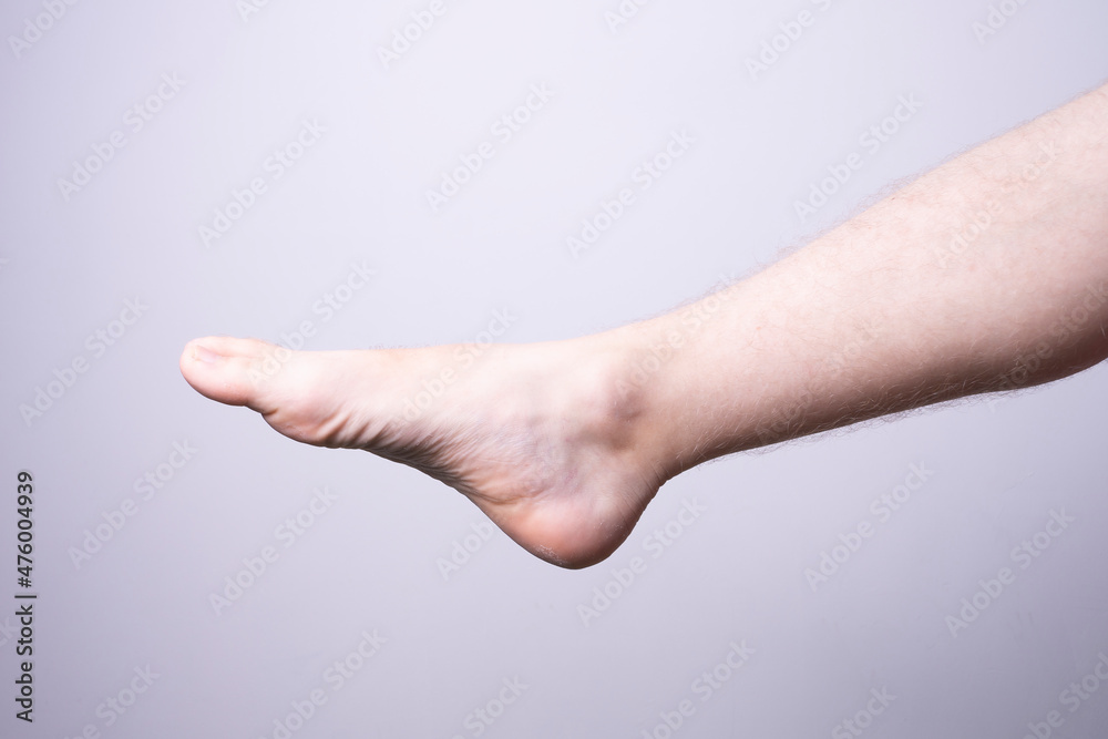 isolated male leg on gray background isolated male leg on gray background