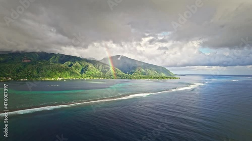 Aerial view of beautiful tropical island, rainbow, blue ocean and coral reefs. Paradise island of Tahiti in French Polynesia.  photo