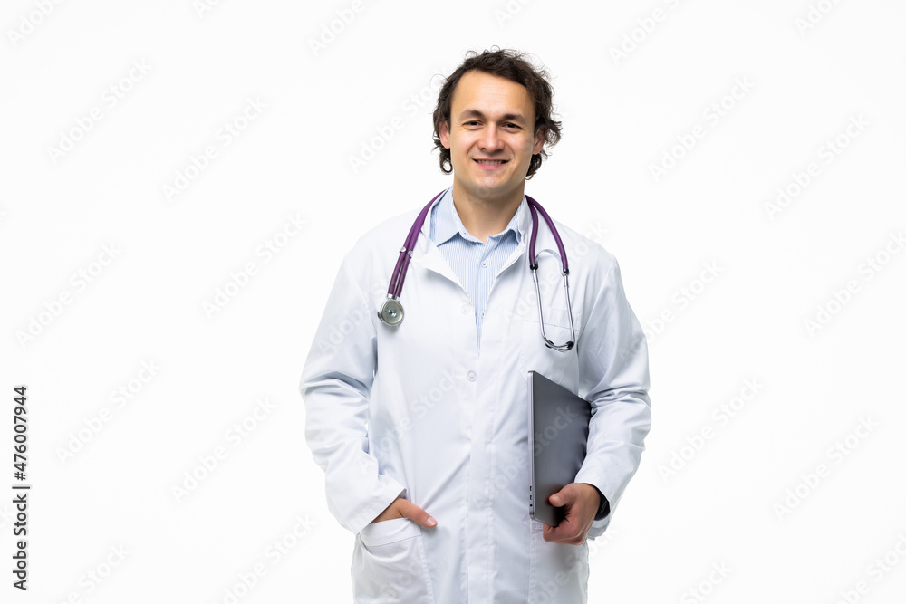 Portrait of a male doctor holding laptop computer and looking at camera on a white background Portrait of a male doctor holding laptop computer and looking at camera on a white background