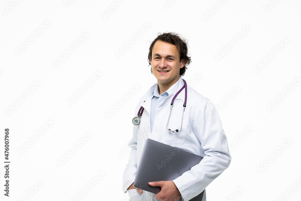 Portrait of a male doctor holding laptop computer and looking at camera on a white background Portrait of a male doctor holding laptop computer and looking at camera on a white background