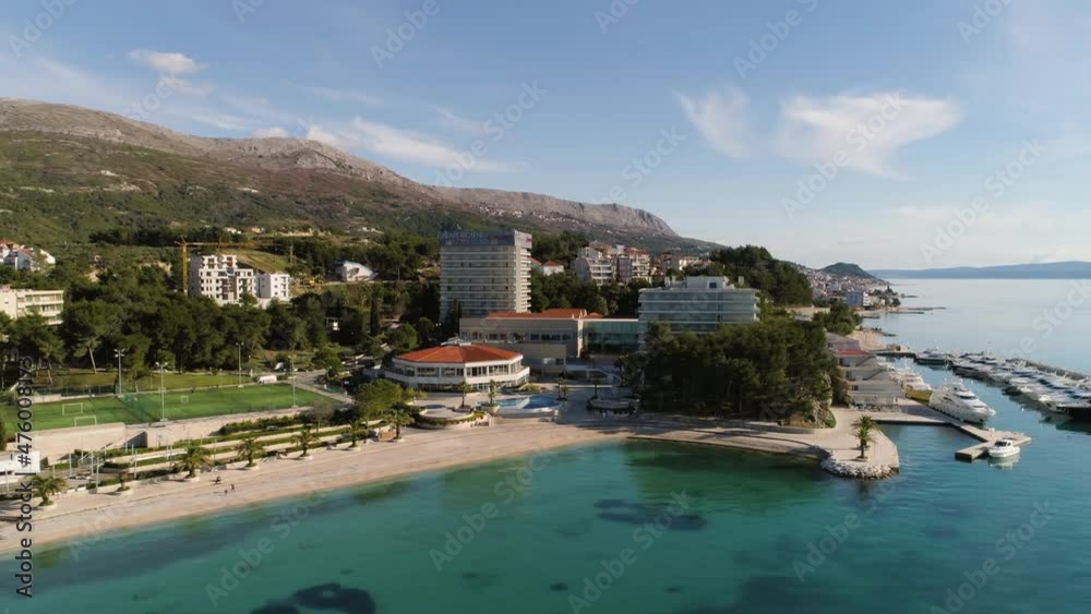 Luxury hotel with yachts docked in small pier ir Croatia, aerial orbit shot